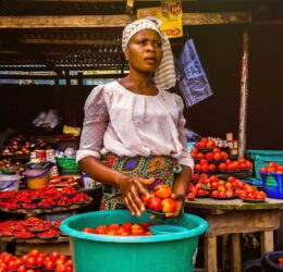 woman holding tomatoes