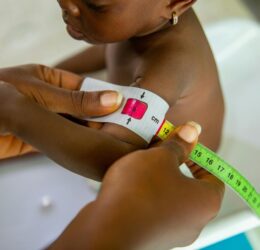 a person using a muac tape on a child